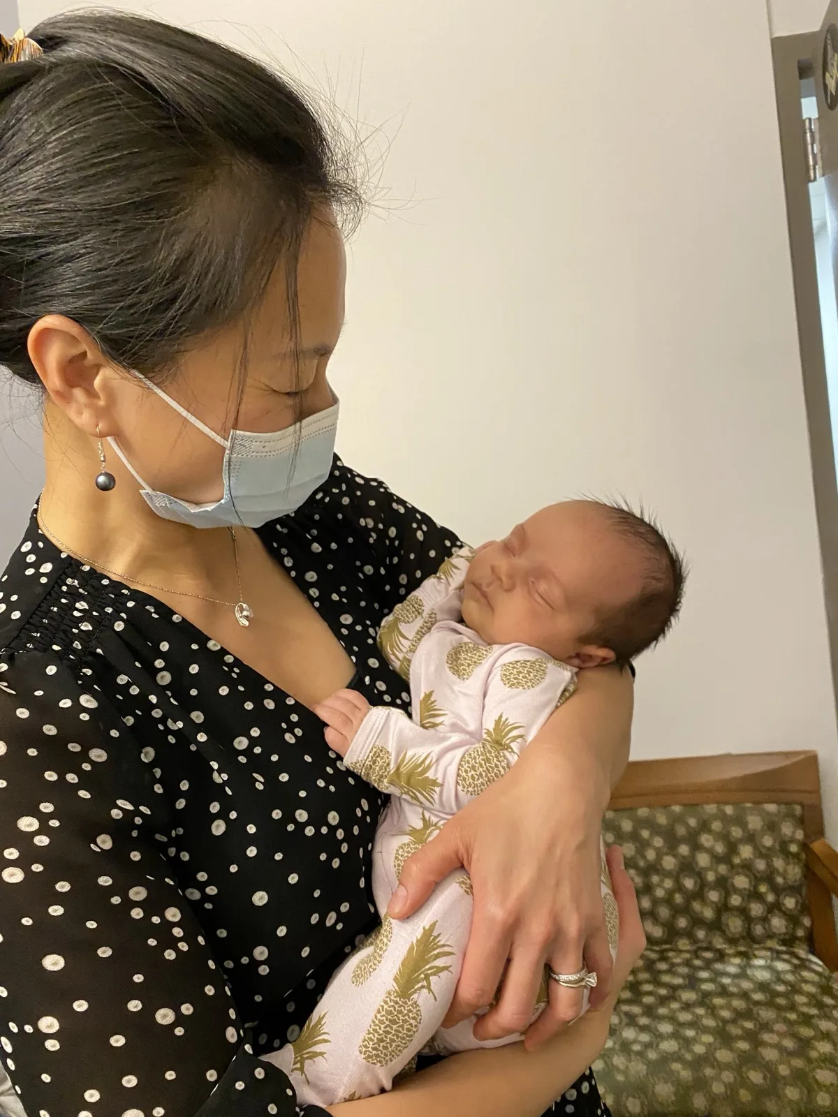 Dr. Lily Yu Gillespie cradling a sleeping newborn — postpartum care and bonding